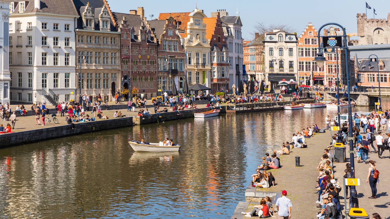Tourists enjoying a sunny day along Leie River in Ghent, Belgium