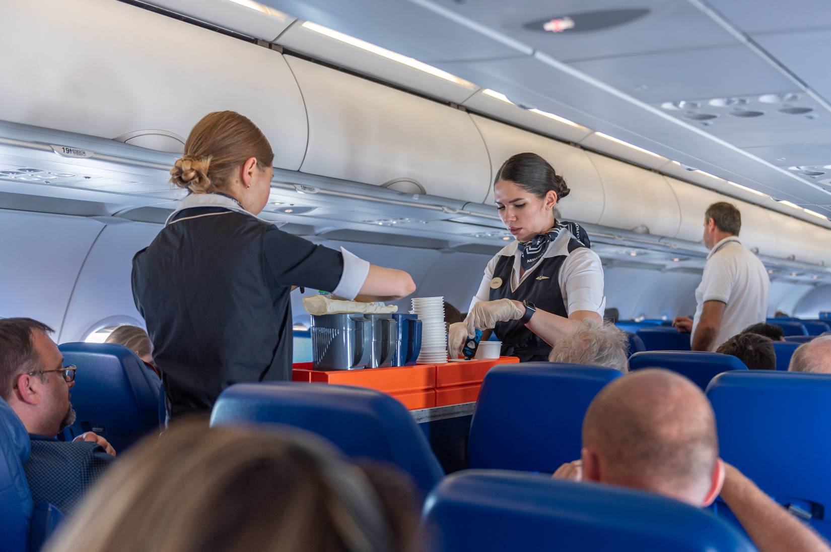 Flight attendants serving food and beverages during a flight