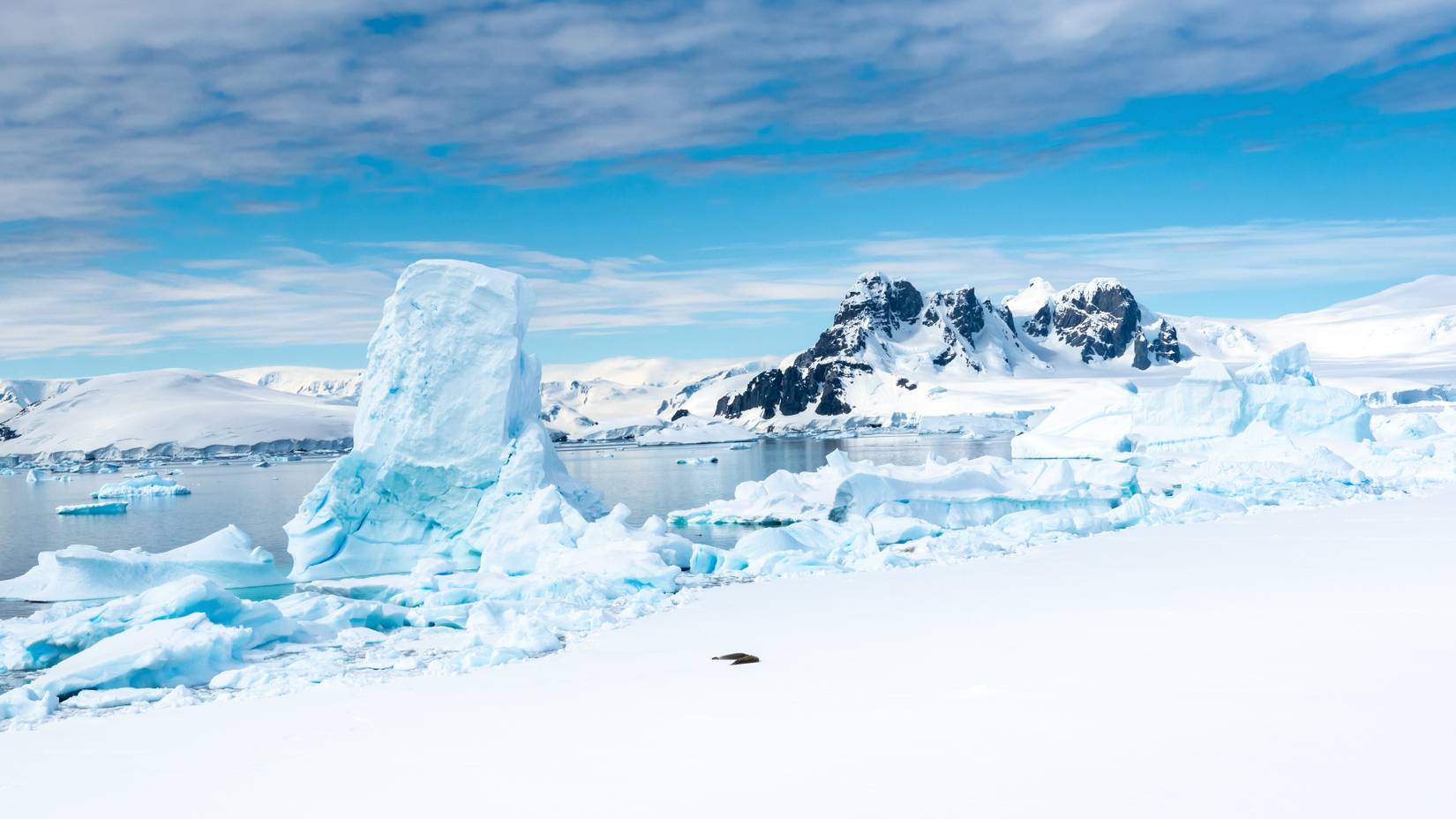 Snow-capped mountains and melting glacier Ice in Hanusse Bay, Antarctica