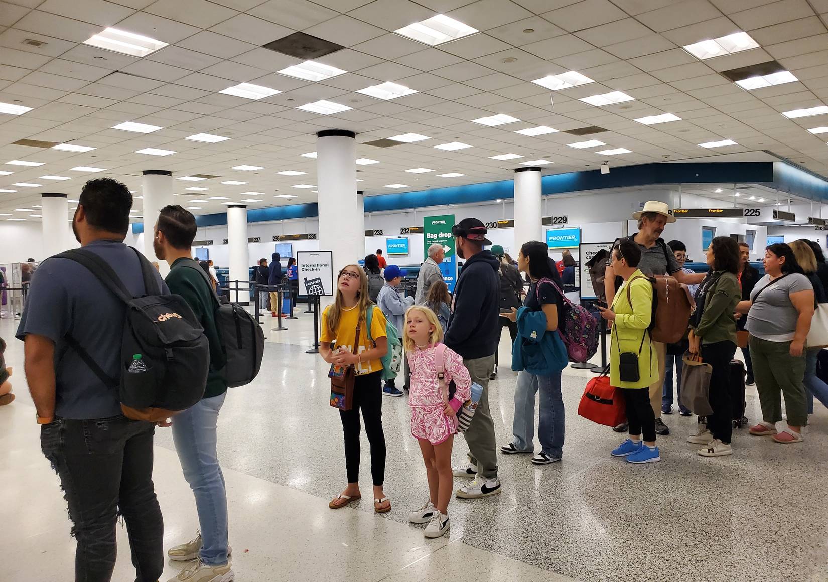Passengers waiting in line to check in their bags inside of the terminal at Miami International Airport, Florida, USA