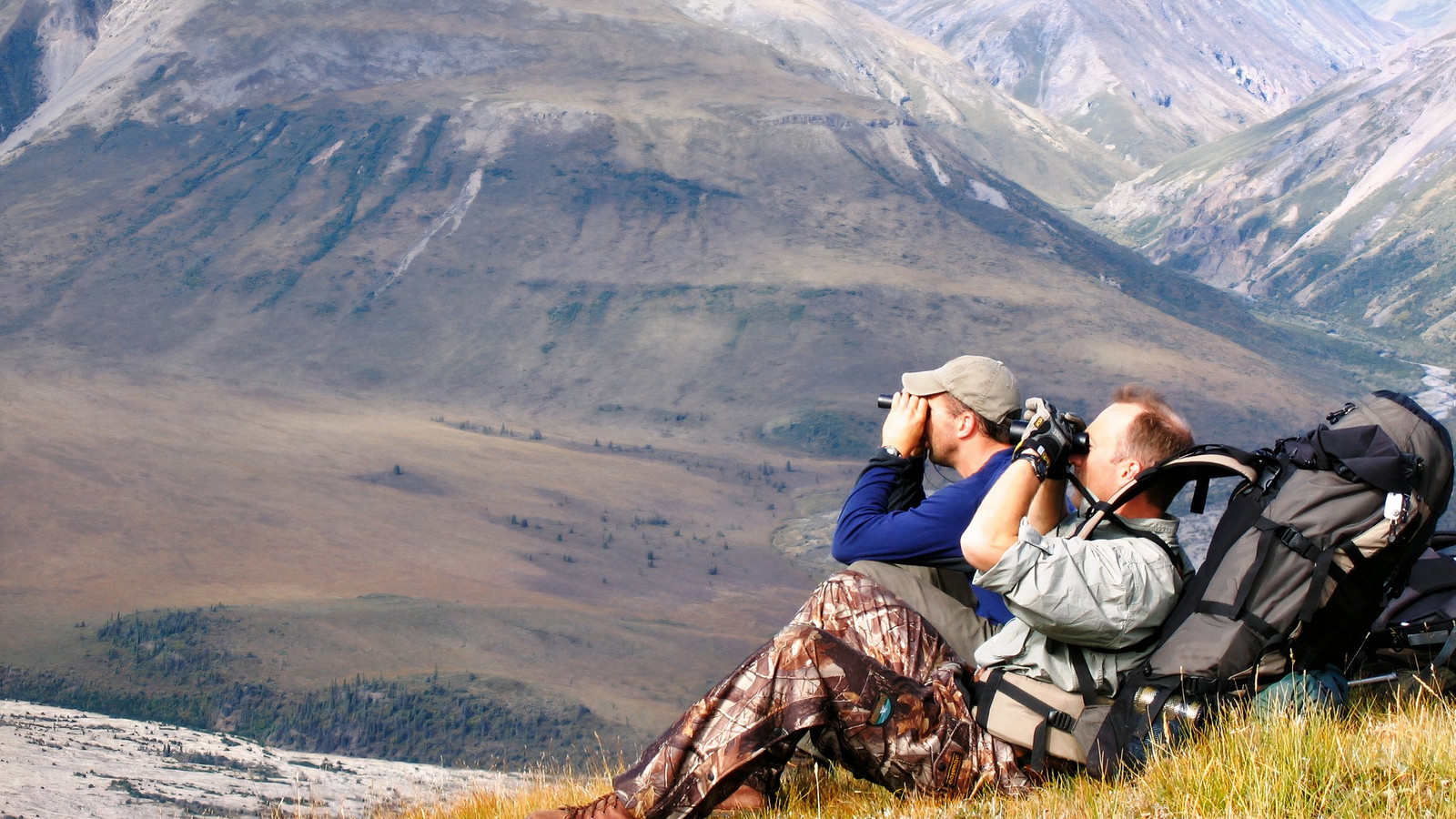 Two hunters looking out for sheep to hunt at Wrangell-St. Elias National Park, Alaska