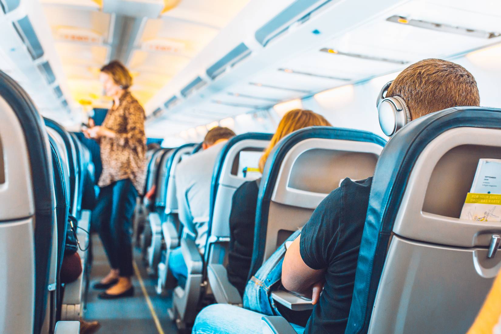 Plane cabin during a flight - passengers in their seats