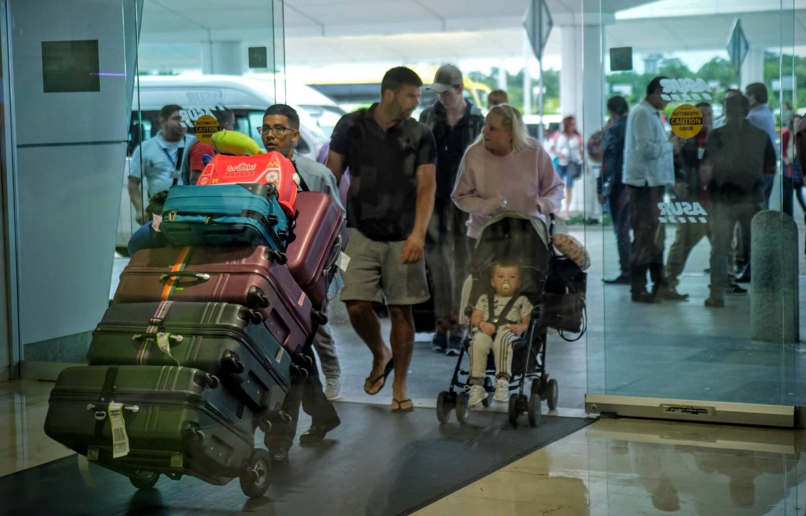 Cancun Airport travelers entering the airport following taxi ride.