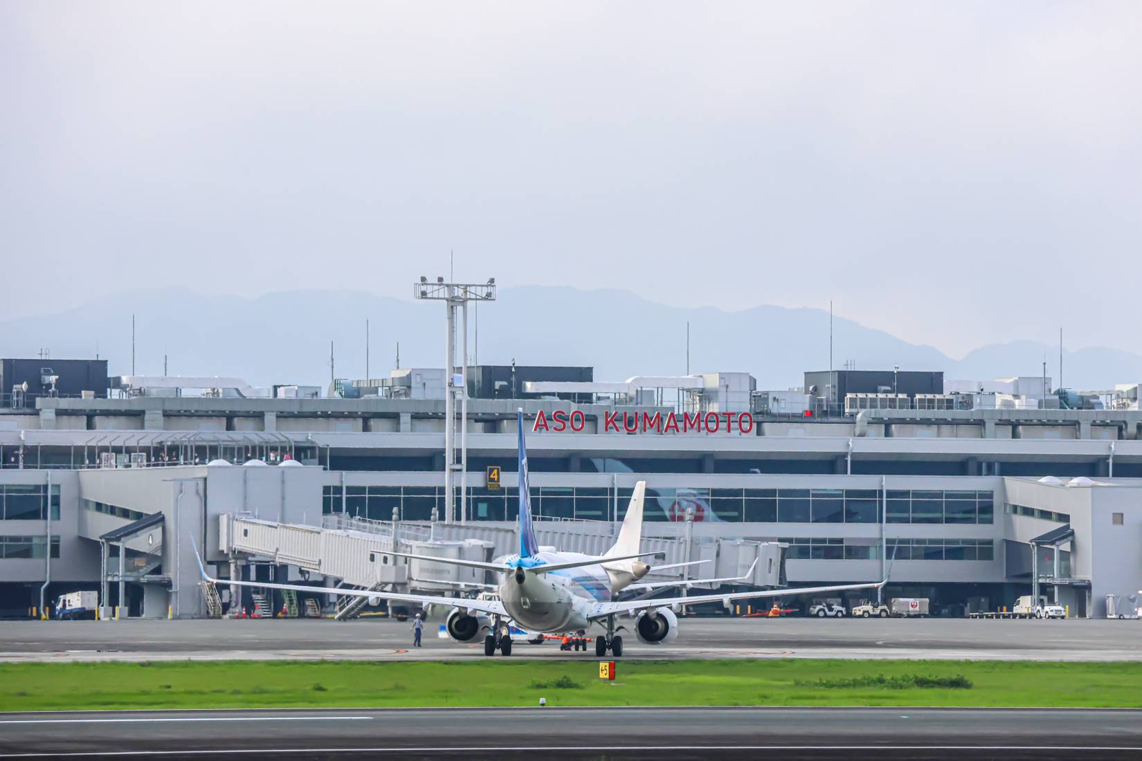 Kumamoto Airport terminal under blue sky