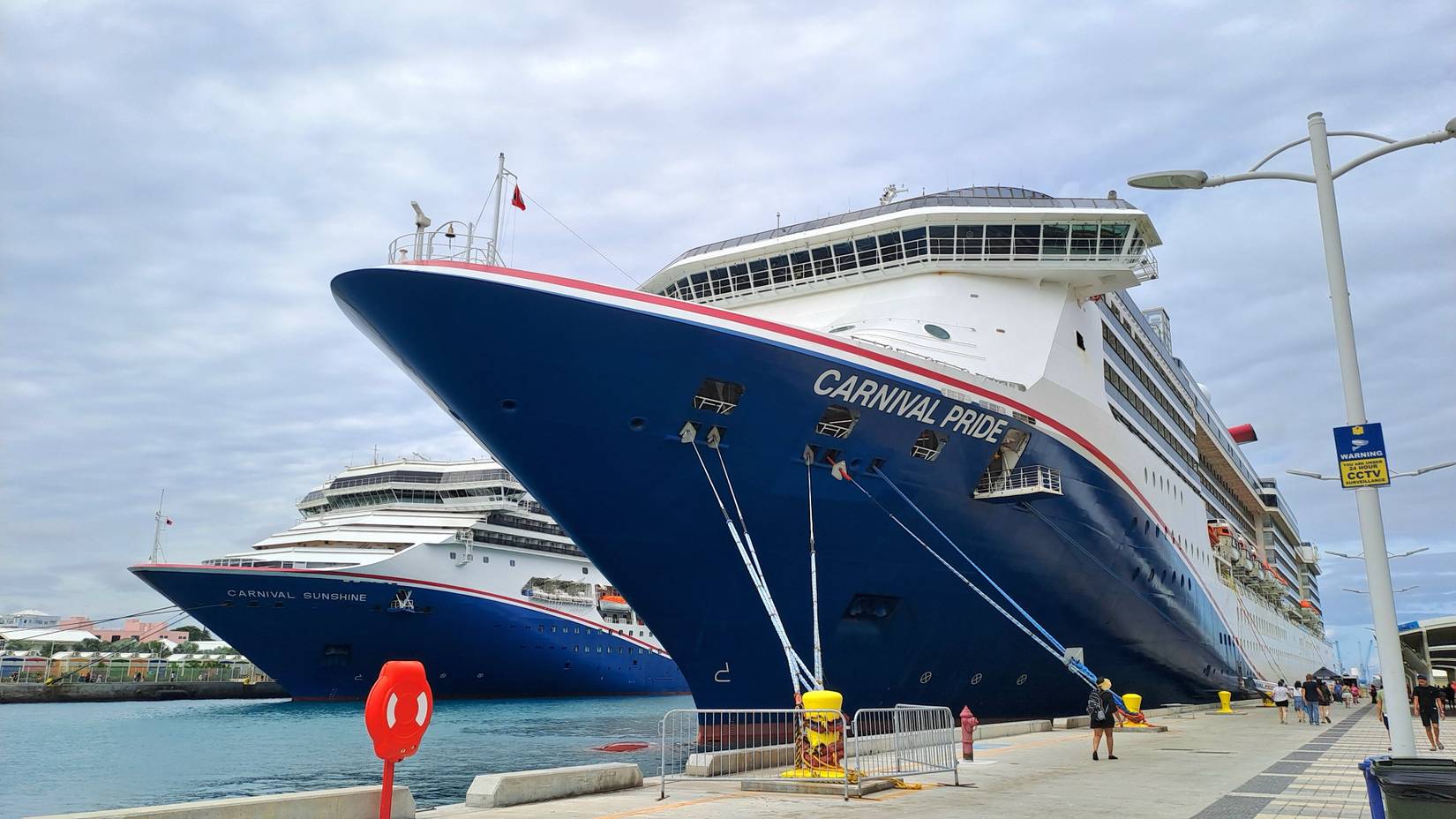 Two large cruise ships from Carnival cruise line docked side-by-side in a port