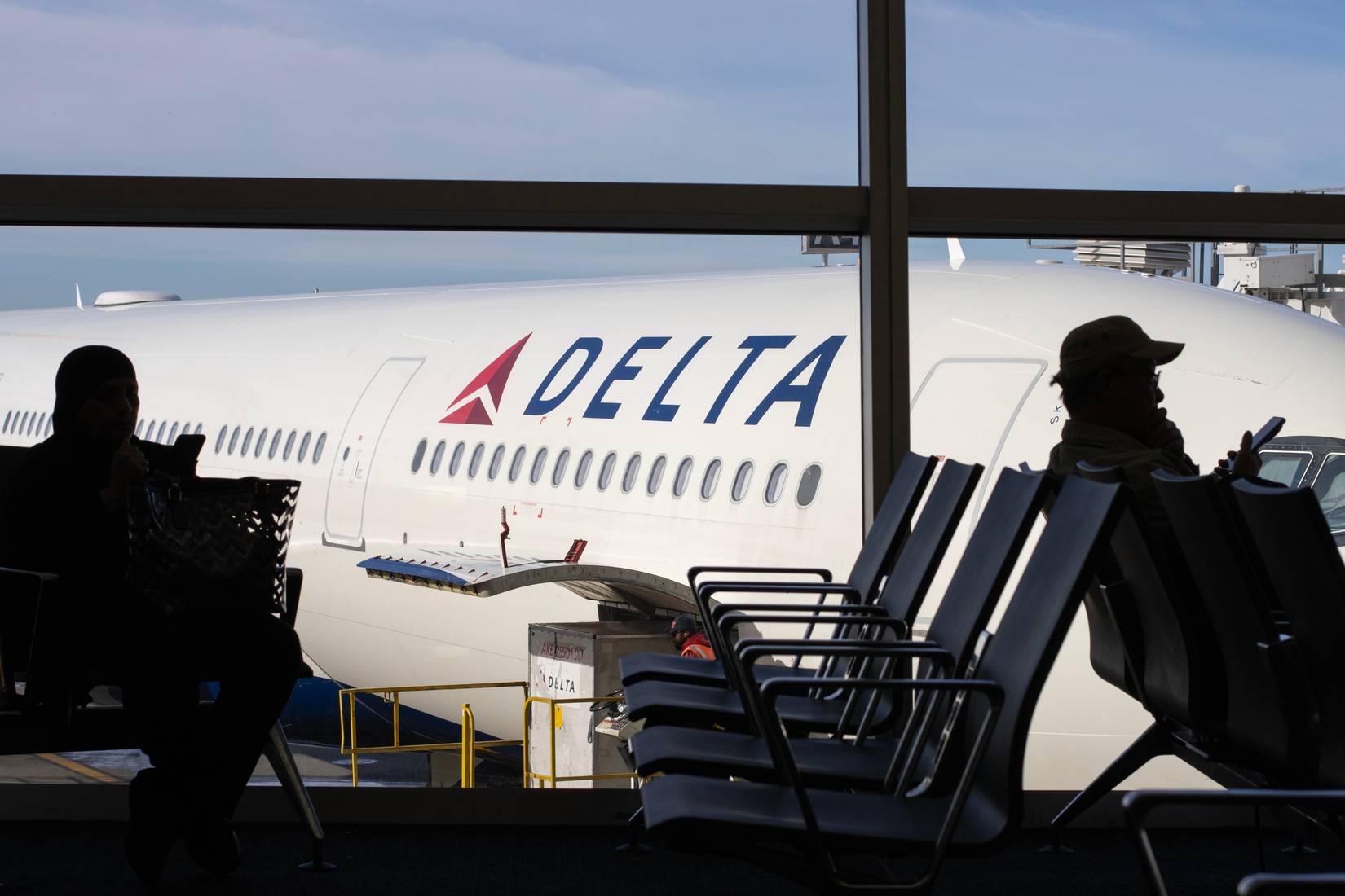 Delta Air Lines customers waiting for flights during delays.