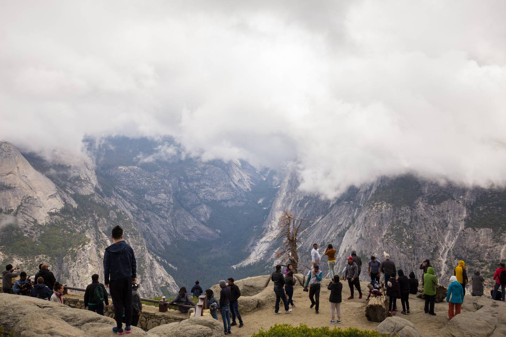Visitors at Yosemite National Park on a cloudy day.