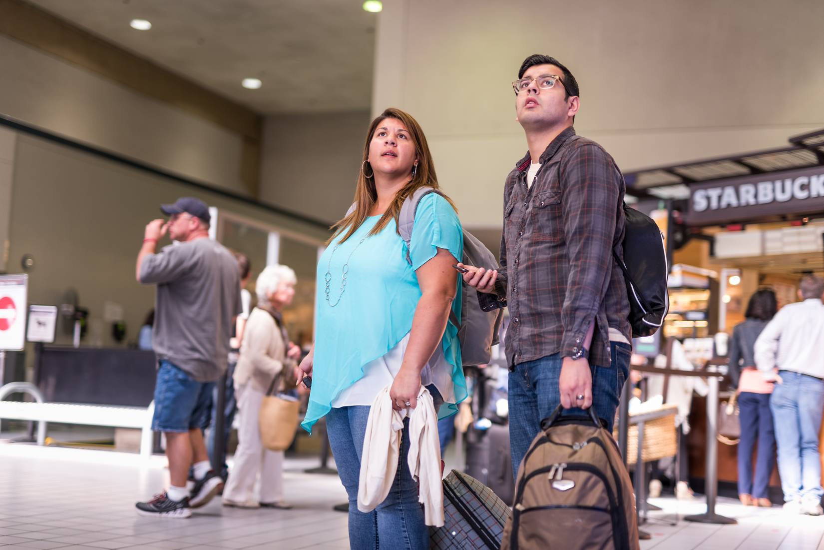 DFW Airport passengers looking on during delays.