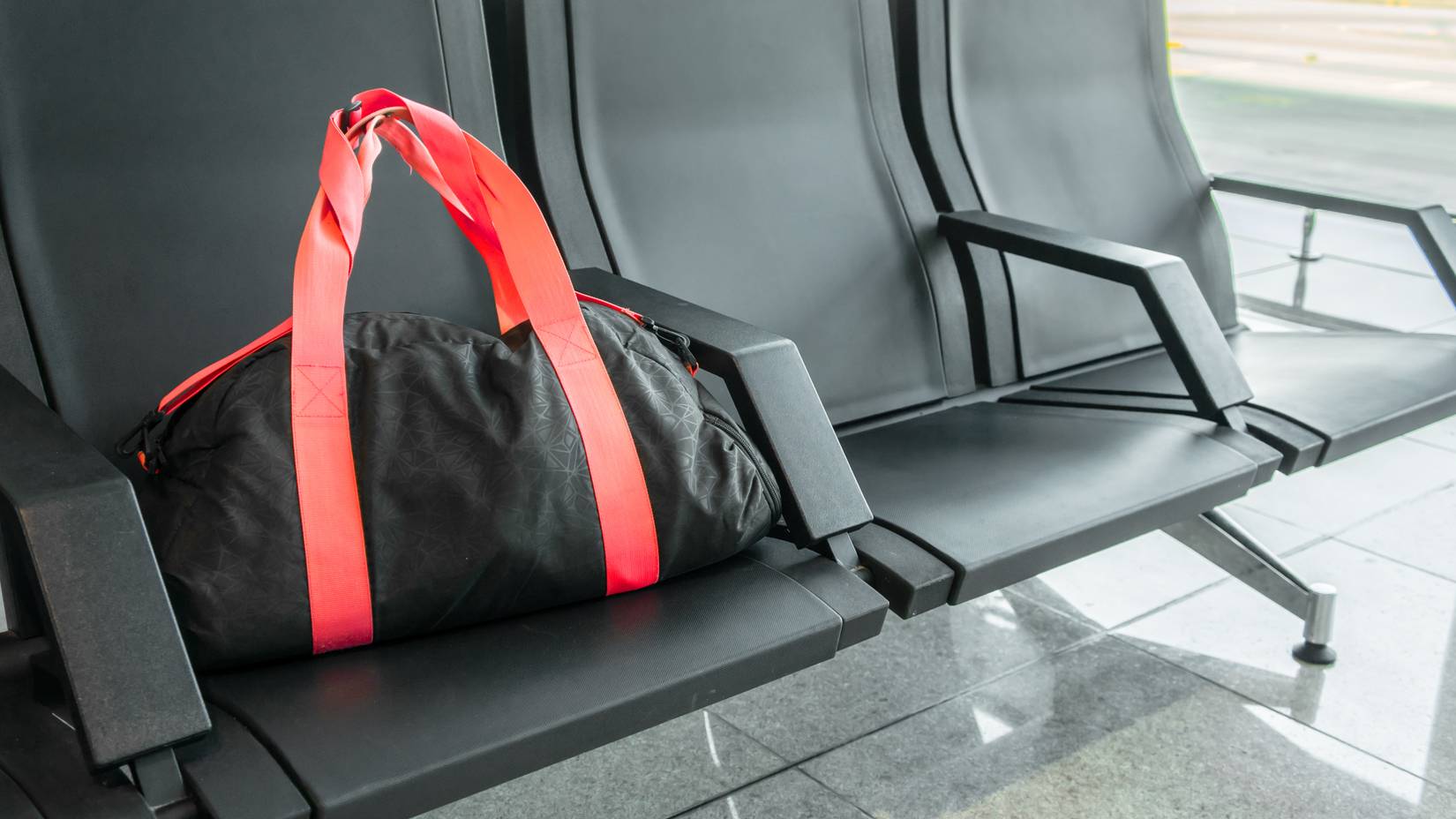 Suspicious black sport bag left on chairs unattended