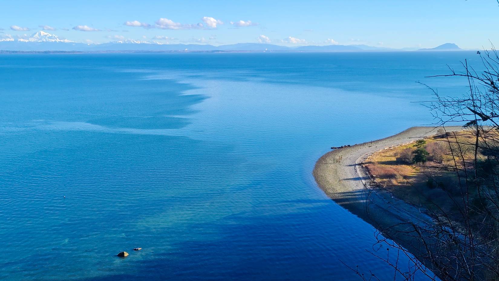 The crescent shoreline at Lily Point Marine Reserve with Mount Baker in the distance, Point Roberts