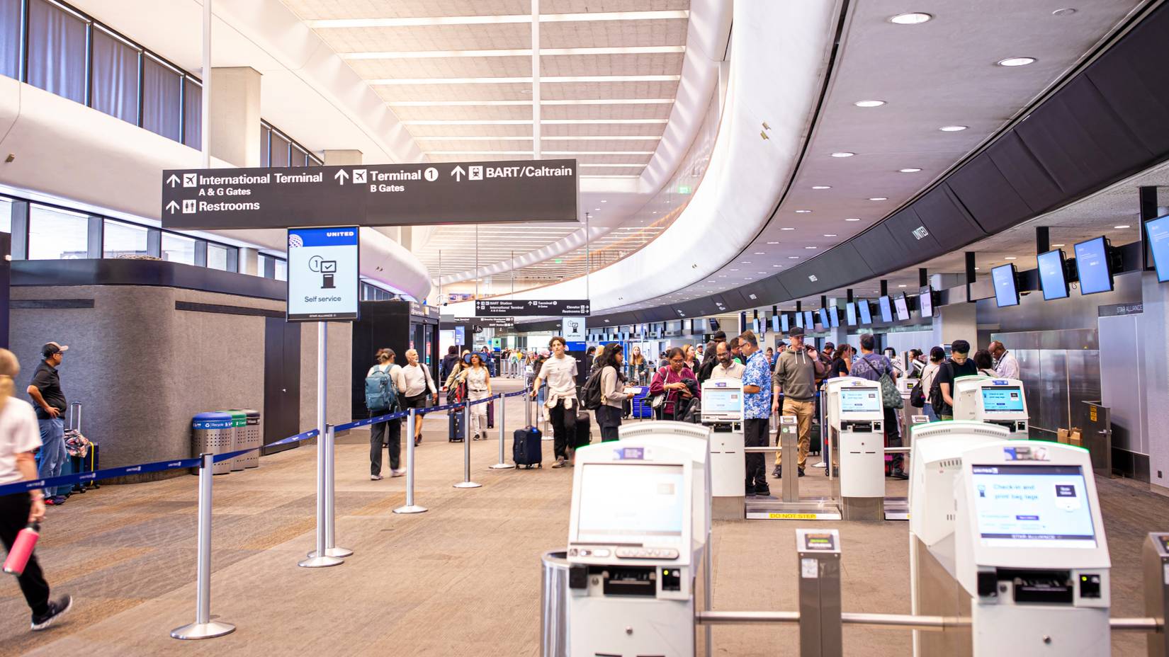 Passengers using United Airlines' self-service kiosks at San Francisco International Airport (SFO)
