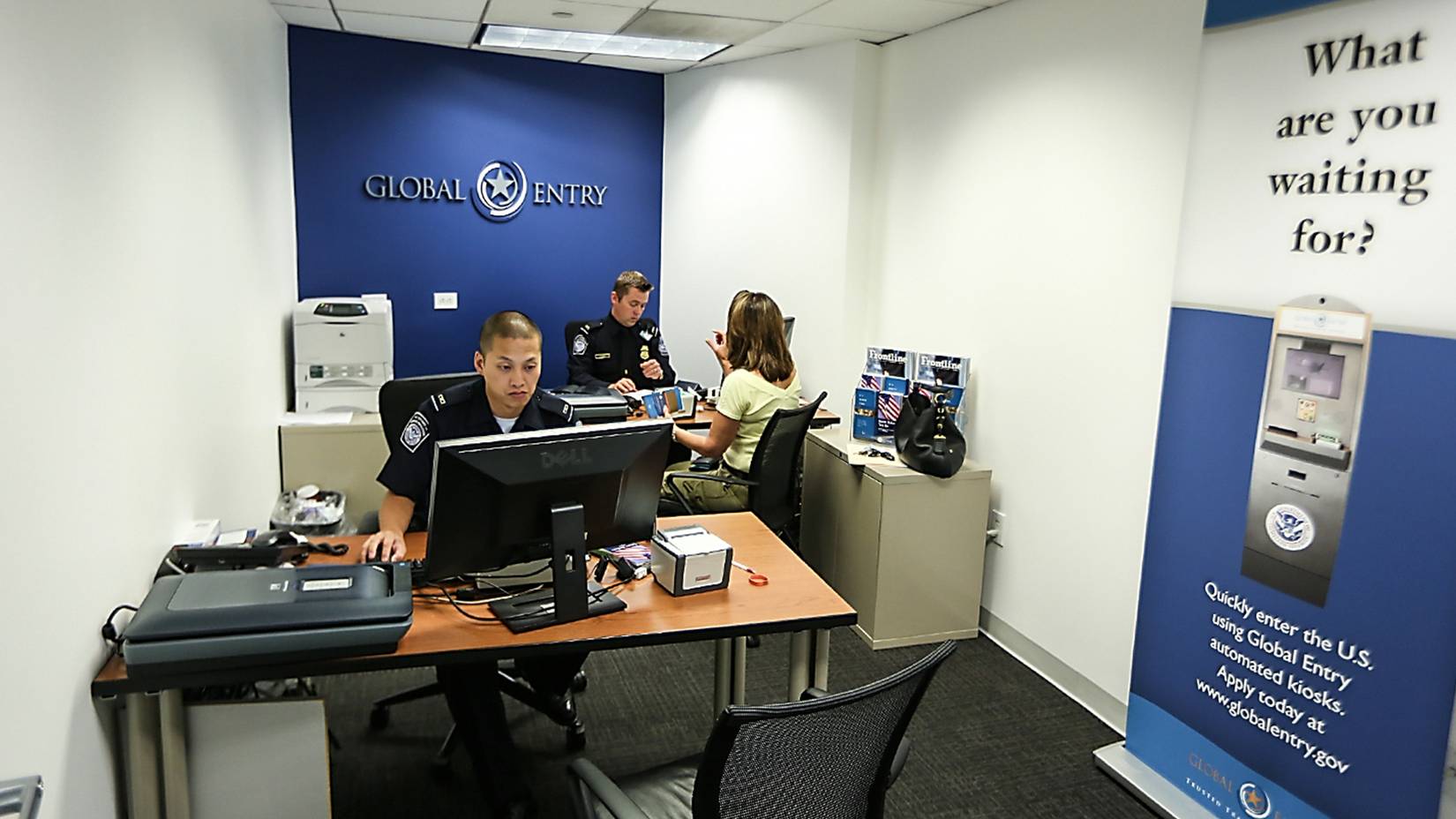 A U.S. Customs and Border Protection officer collects information from an enrollee during a Global Entry interview