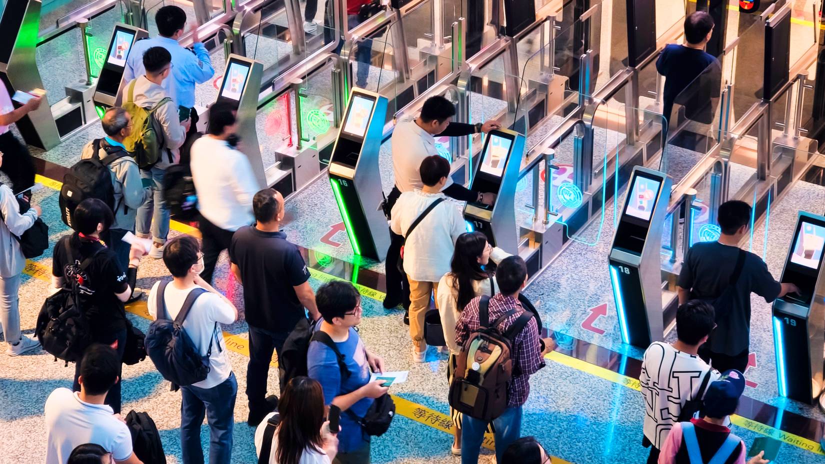 People pass through an automated passport check at the immigration control at Taoyuan International Airport (TPE), which serves Taipei, Taiwan