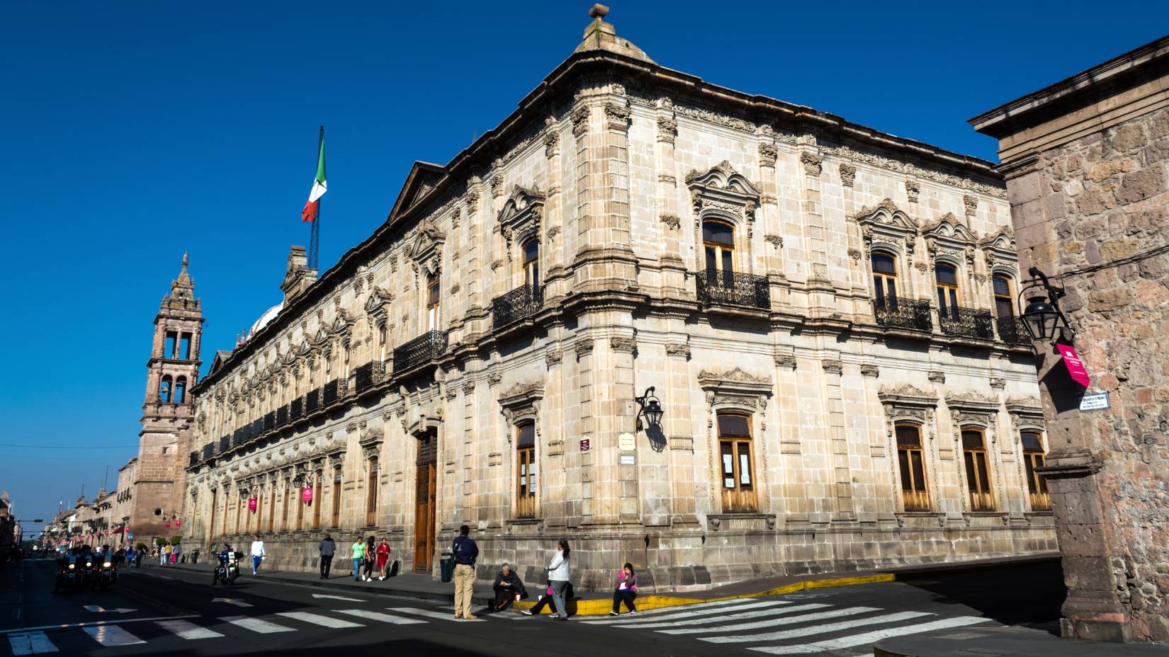 Tourists walking by the Palacio Federal building in the historic center of Morelia, Michoacán, Mexico