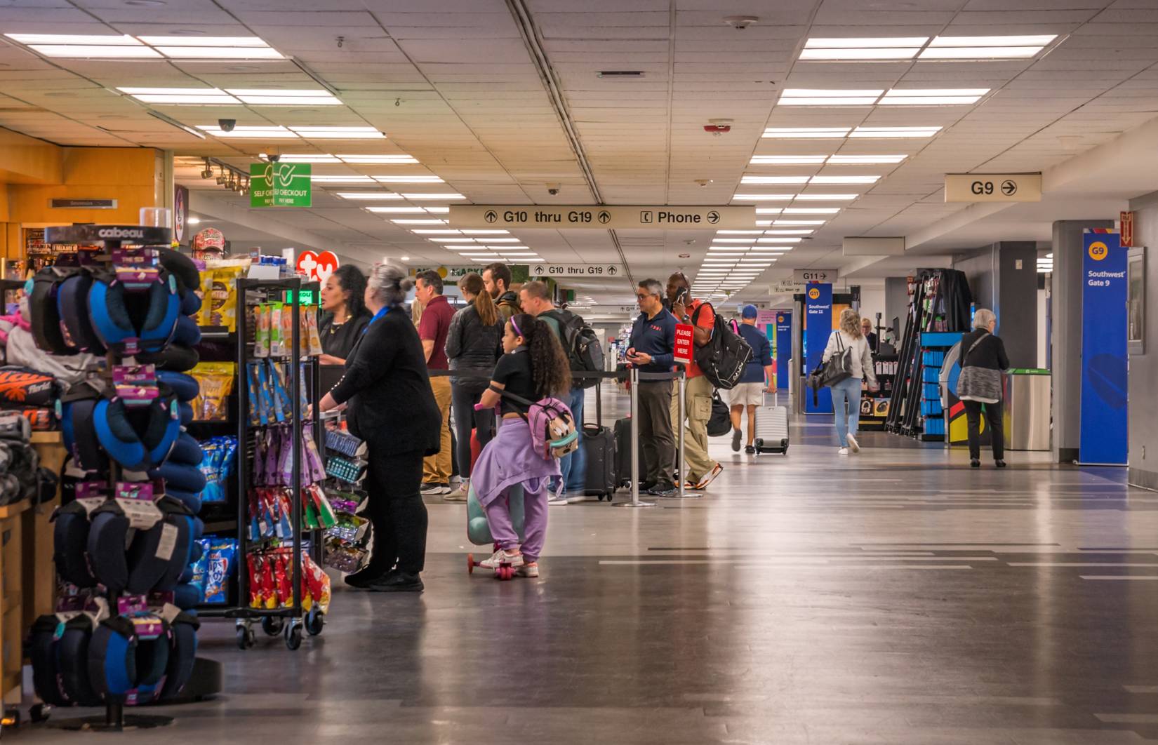 Passengers lined up in the crowded hall of Miami International Airport, Miami, Florida, USA
