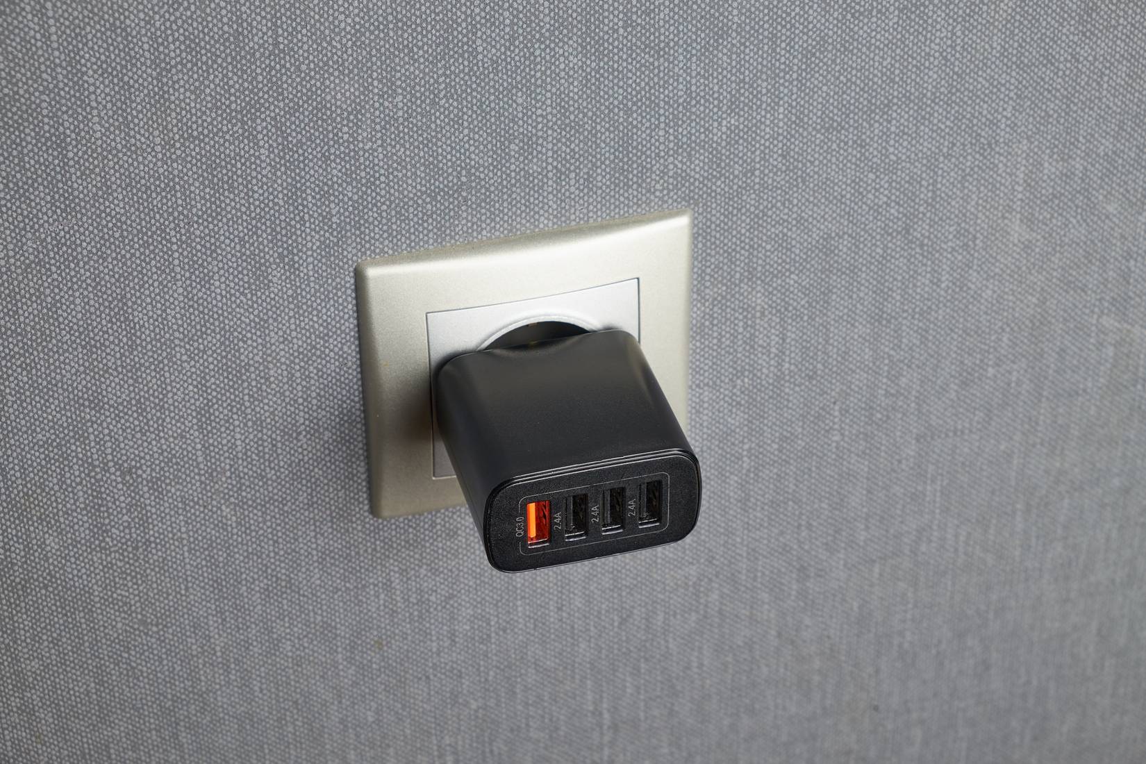 Multi-port USB charger plugged into a wall socket.