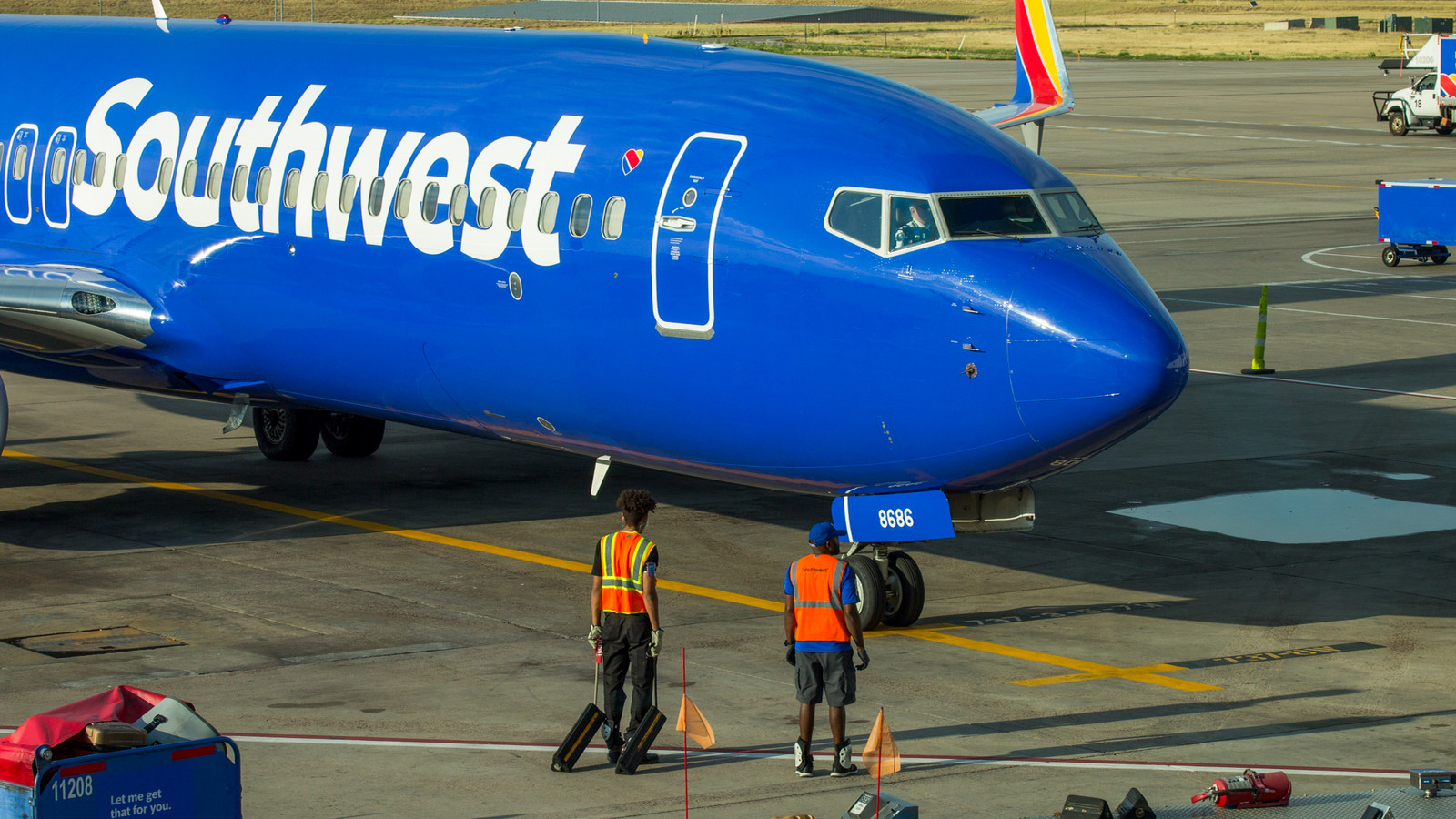 Southwest Airlines 737 arrives at a gate as ground personnel approach the aircraft