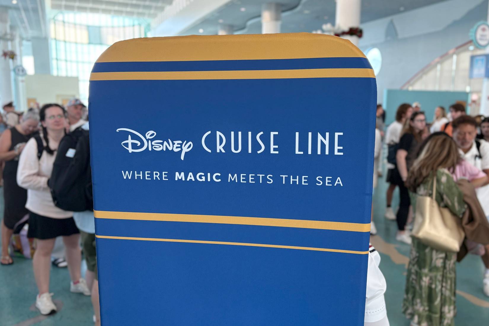 Travelers wait to board a Disney Cruise Line ship in Port Canaveral