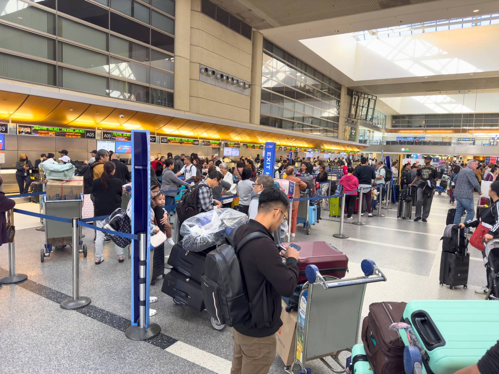 U.S. airline passengers are delayed in long lines at Los Angeles International Airport (LAX).
