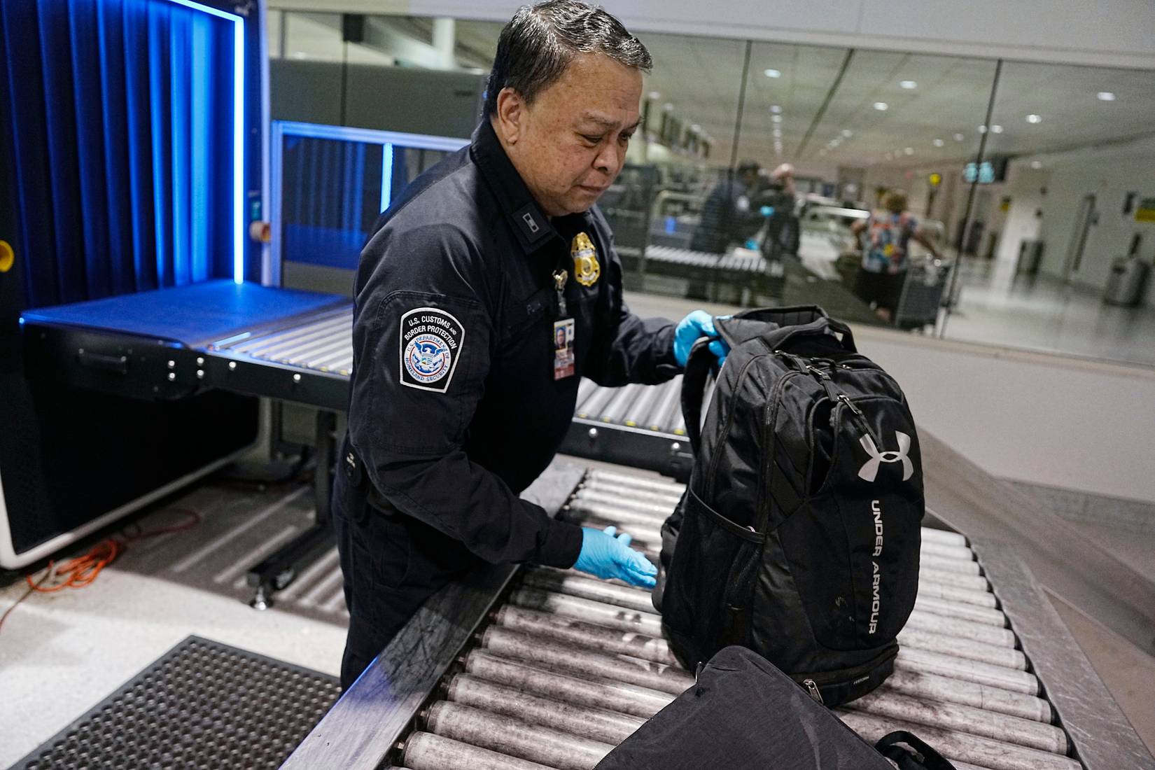 U.S. Customs and Border Protection (CBP) officers inspecting passenger baggage at Baltimore-Washington International Thurgood Marshall Airport (BWI), USA
