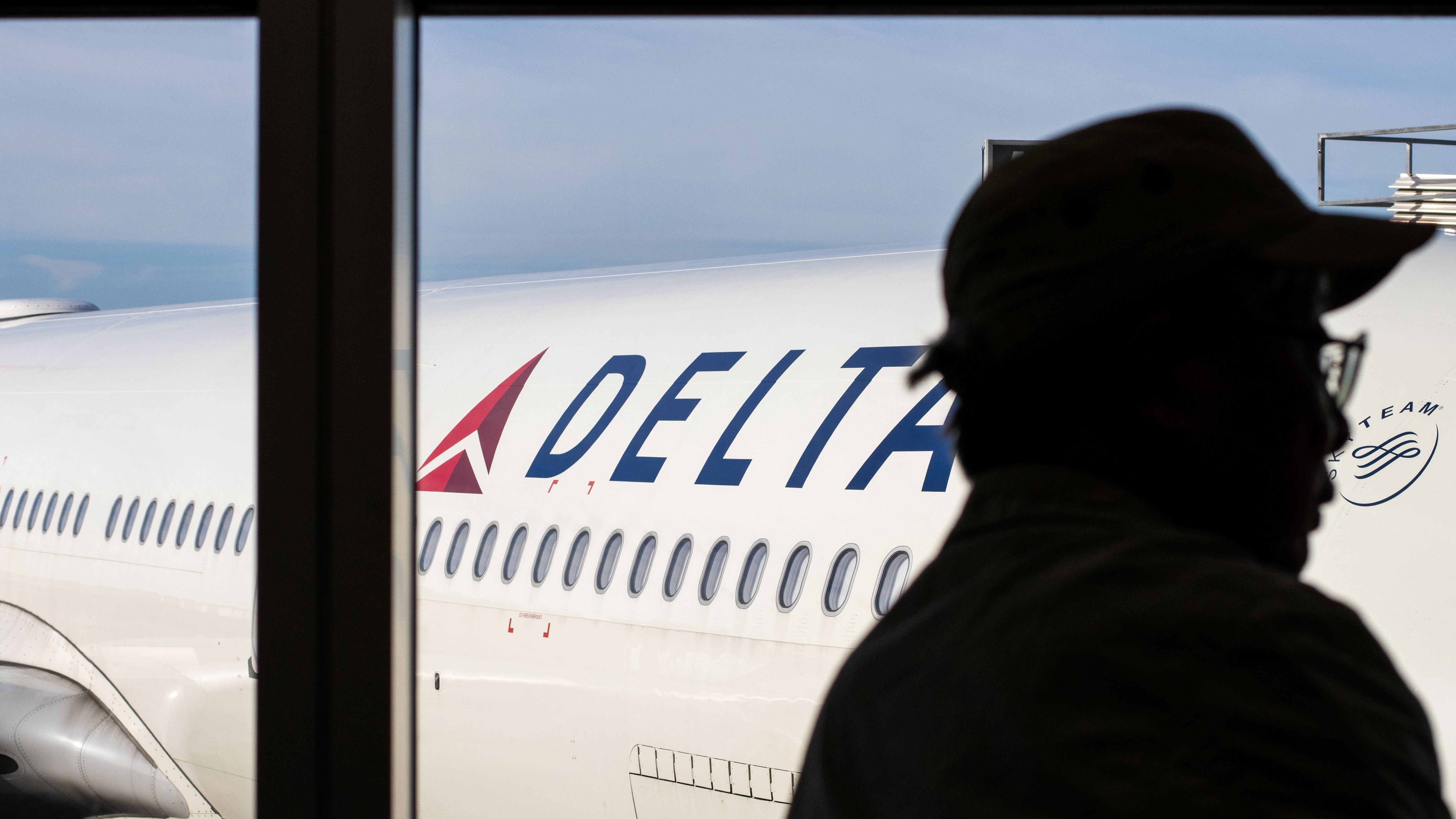 Delta Air Lines passenger silhouette at a terminal gate 