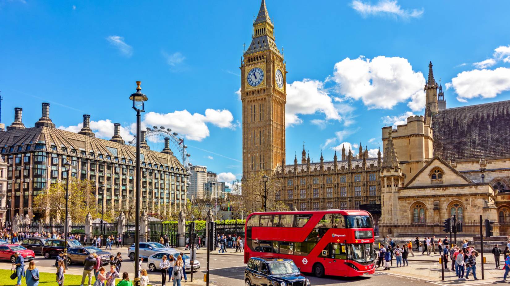 People walking around Parliament Square and Big Ben in London, United Kingdom