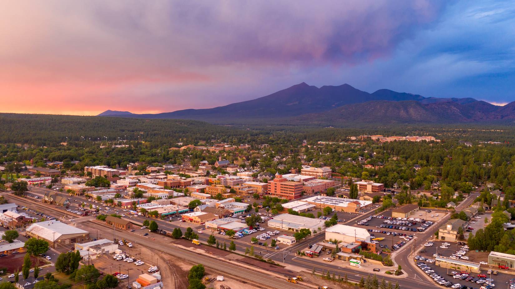 Blue and orange colors swirl around in the clouds at sunset over Flagstaff, Arizona, AZ, USA.