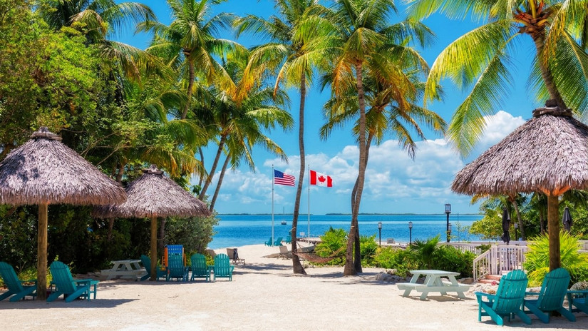 Flags of the United States of America and Canada on a beach in Key Largo, Florida, USA