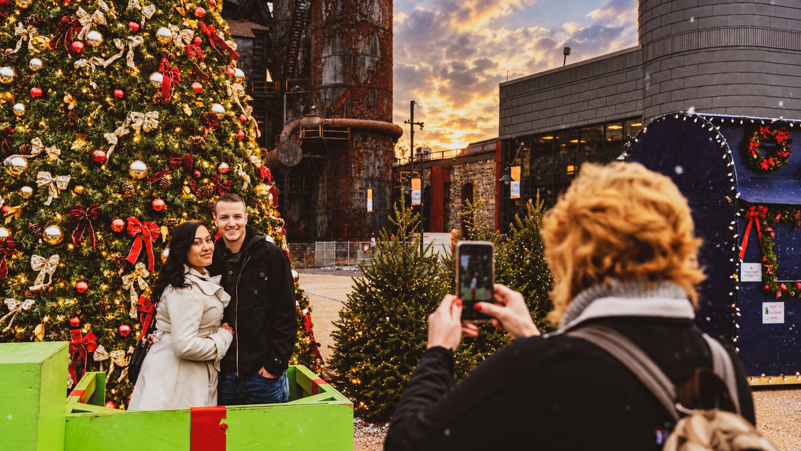 Visitors pose for a photo at the Christkindlmarket, Bethlehem, PA